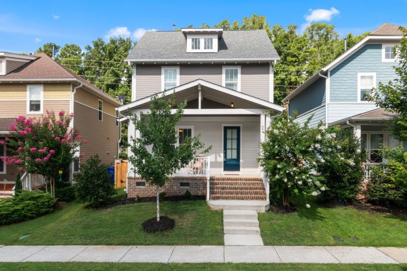 Beautiful suburban home with a well-maintained lawn and vibrant greenery surrounding it.